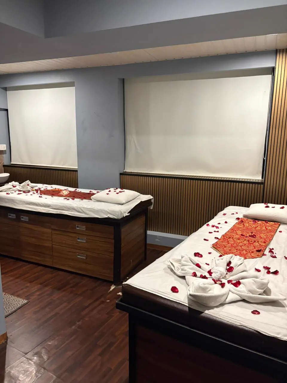 Couple massage suite with twin beds and rose petals at Mitram Luxury Spa