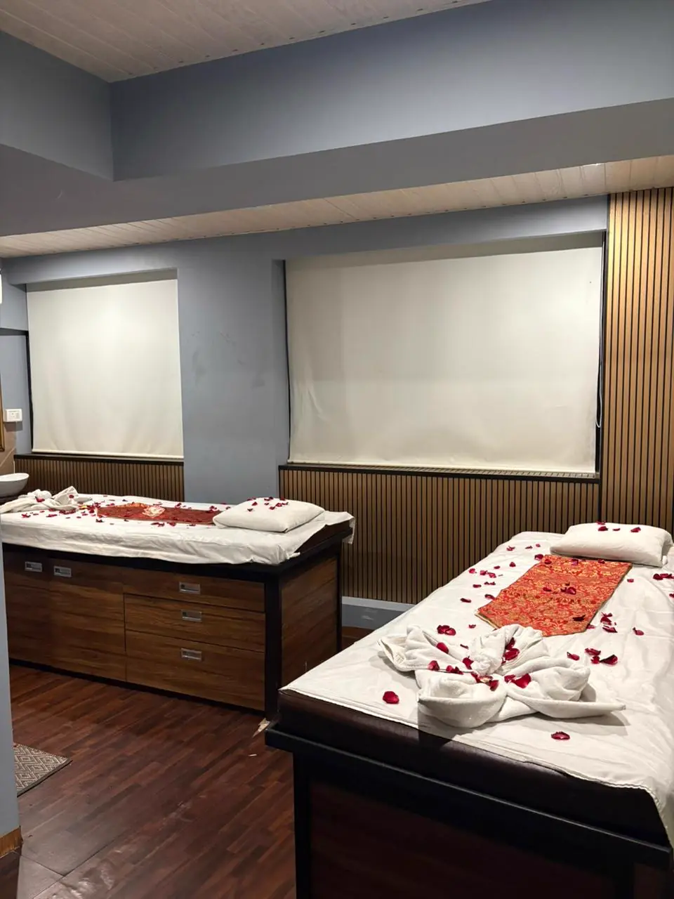 Twin massage beds prepared with fresh linen and rose petals